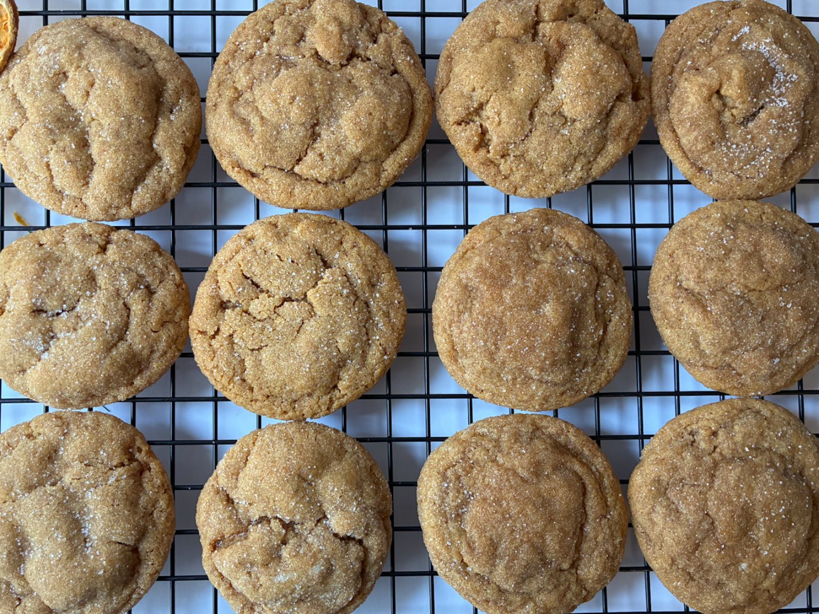12 eggless molasses cookies on a cooling rack
