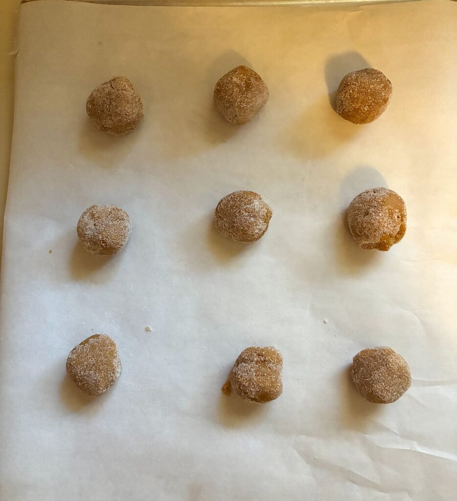 9 dough balls on a baking sheet with parchment paper