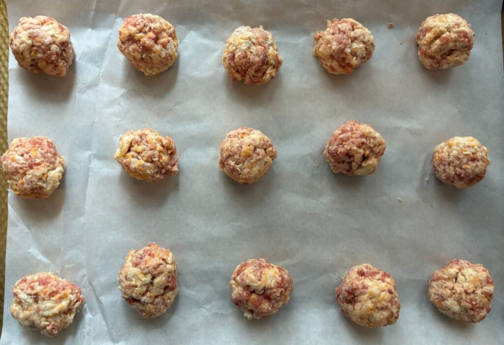 Uncooked sausage balls on a baking sheet