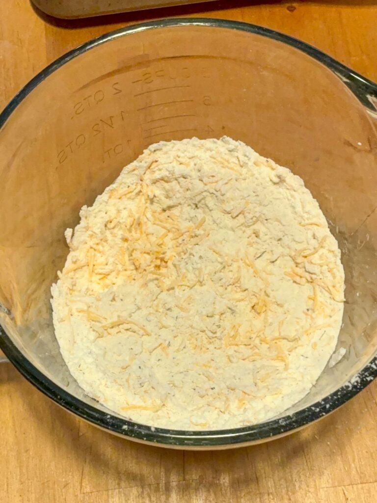 Large mixing bowl with flour and cheese mixture