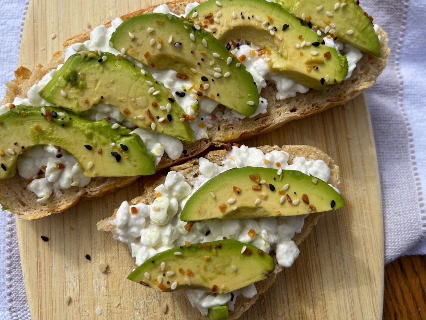 cottage cheese avocado toast on a cutting board