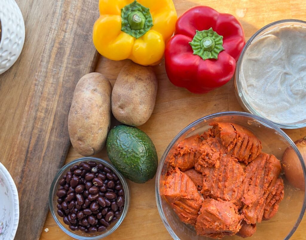 Chorizo breakfast bowl items out on the table with a cutting board next to them