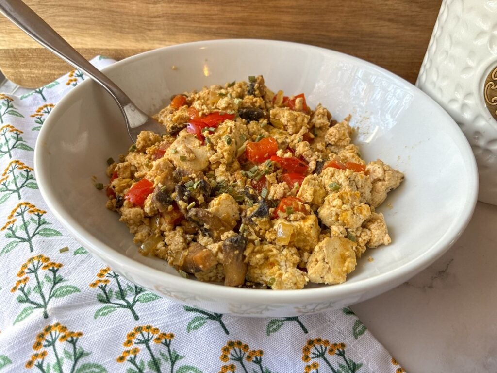 Tofu scramble served in a bowl with a fork