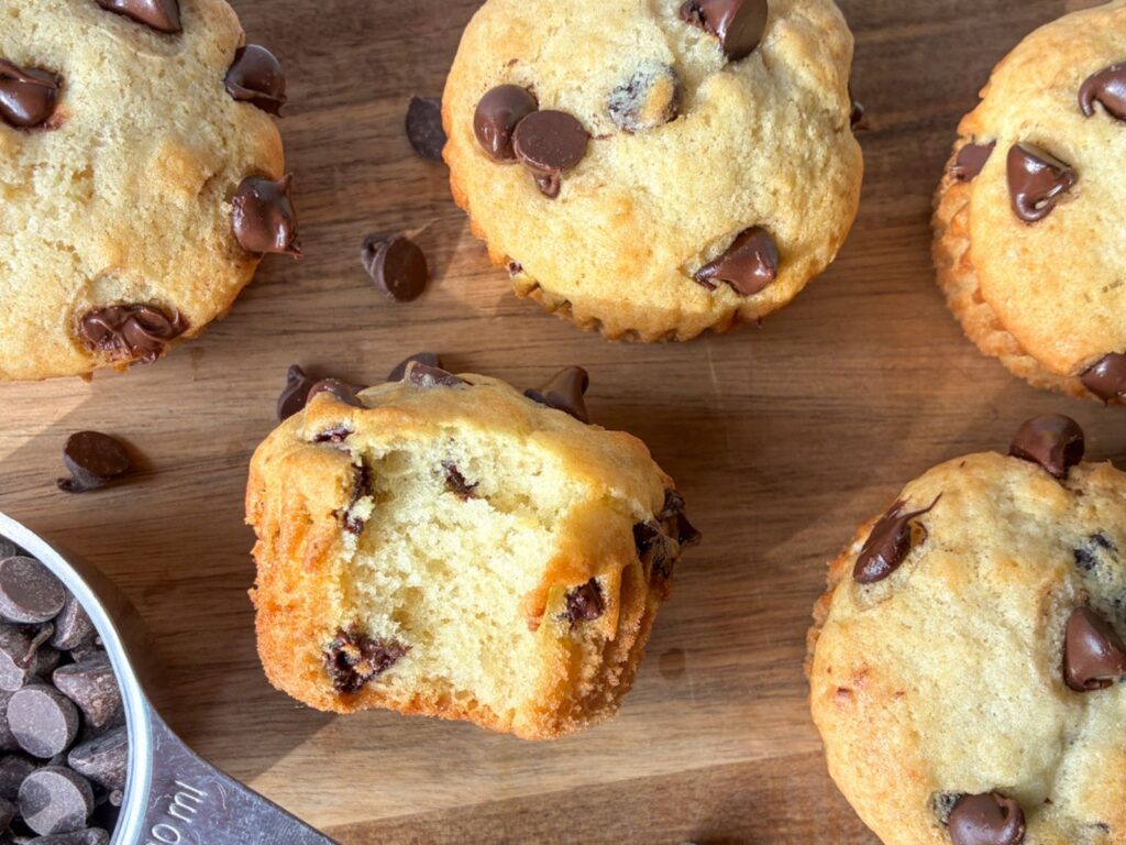 eggless chocolate chip cookies out on cutting board with a bite taken out of one of them