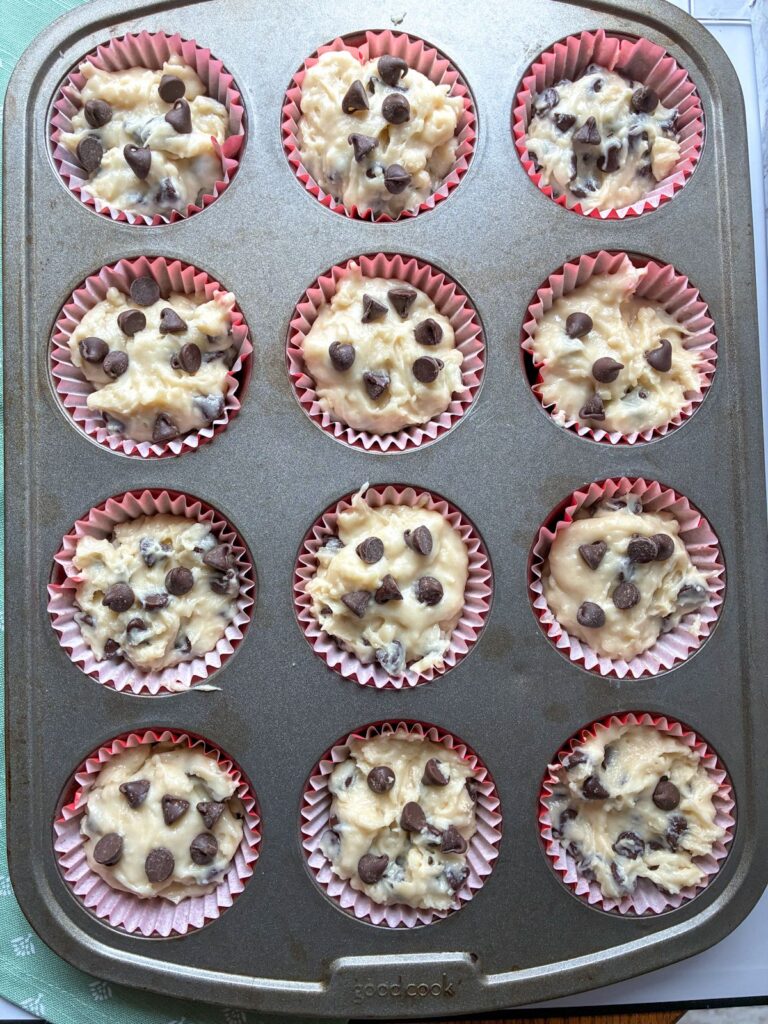 Muffin batter in a 12-cup muffin tin prior to being baked