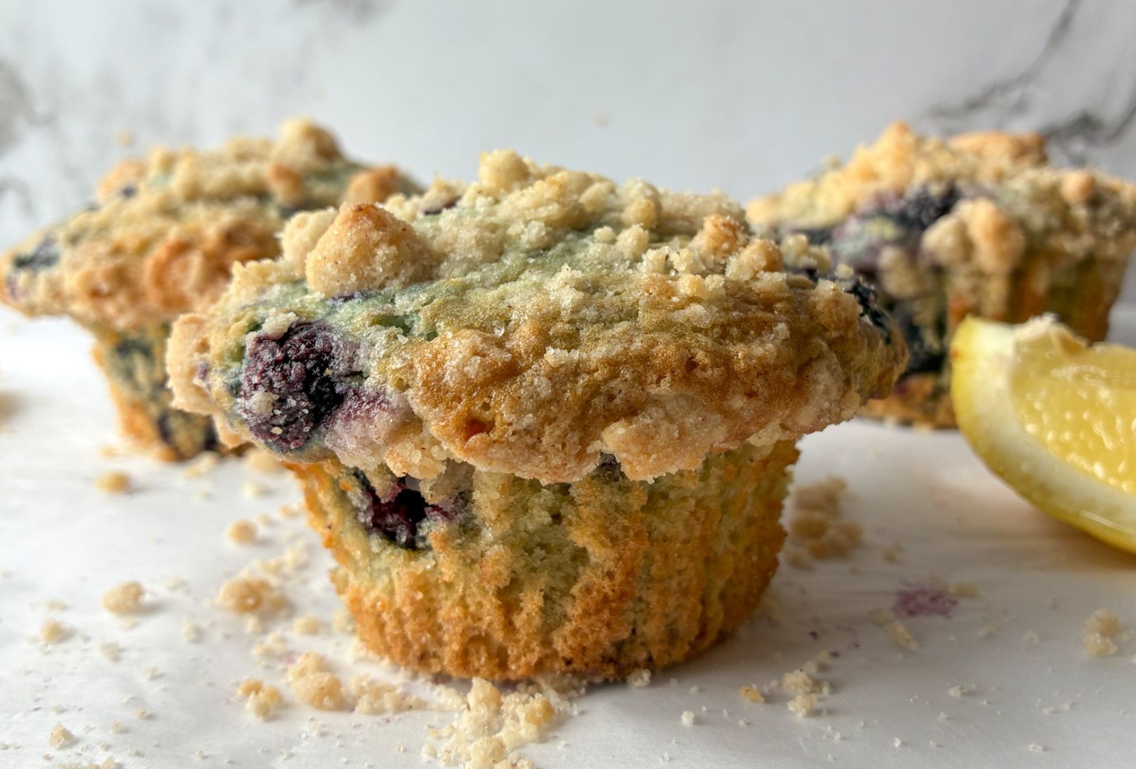 Close up photo of an eggless lemon blueberry muffin