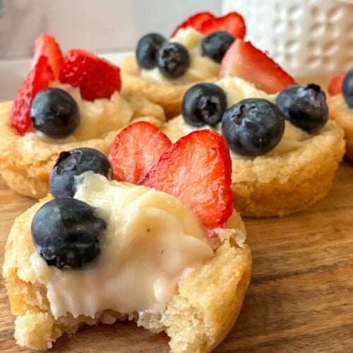 eggless sugar cookie mini tarts one with a bite taken out of them