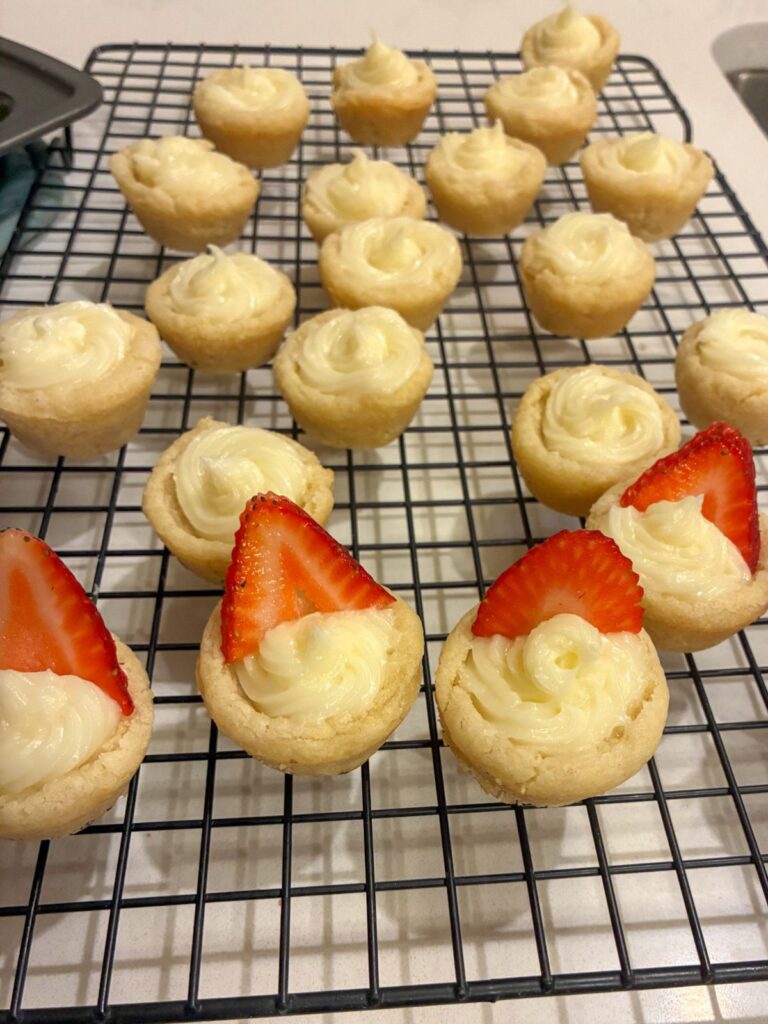 sugar cookie mini tarts on a cooling rack with filling in them