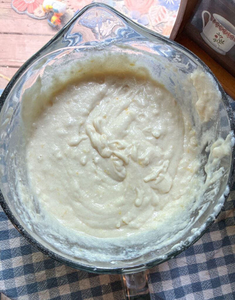 Batter for eggless lemon cake in a large bowl