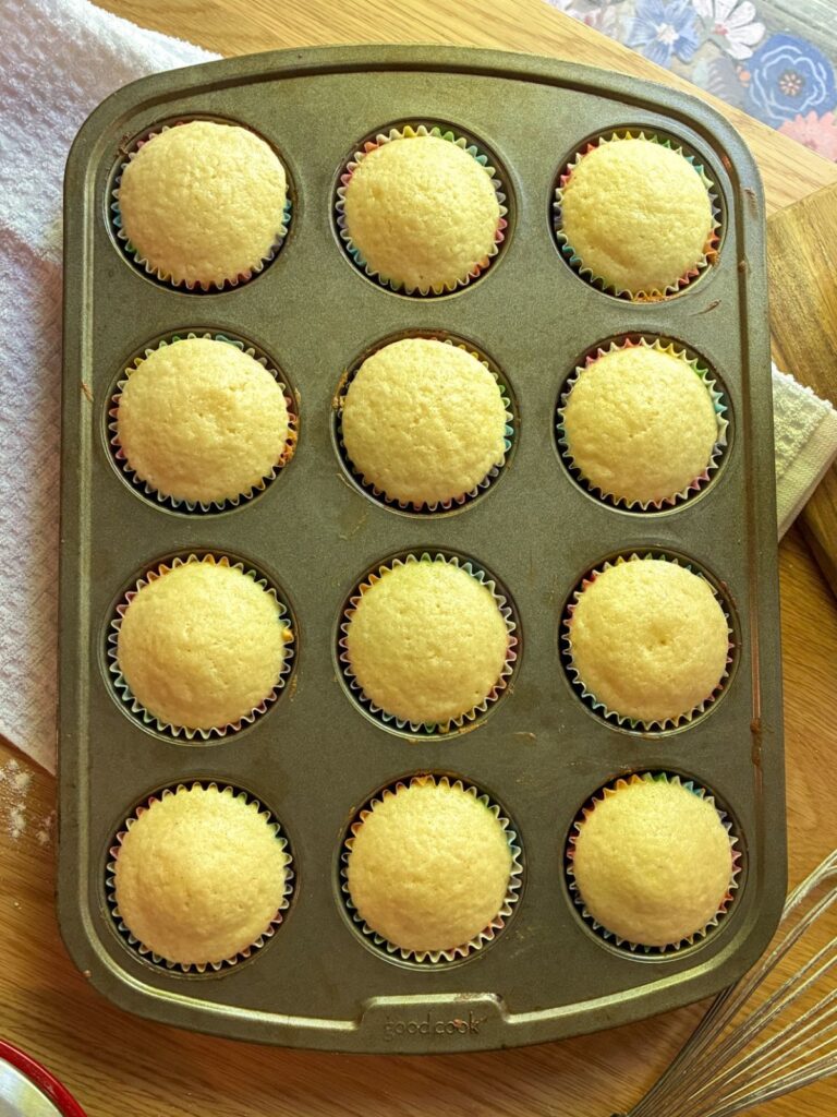 eggless vanilla cupcakes fresh out of the oven still in the muffin pan
