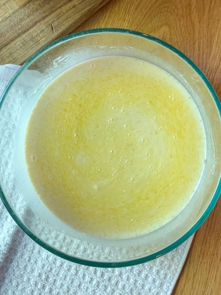 Wet ingredients mixed together in a large bowl for eggless vanilla cupcakes