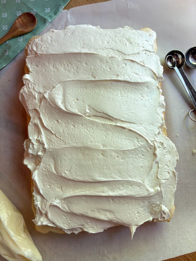 Eggless vanilla sheet cake with whipped buttercream frosting on top