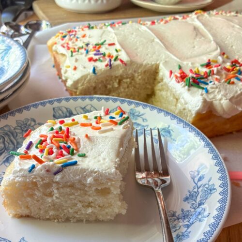 Eggless vanilla sheet cake on a plate with a fork