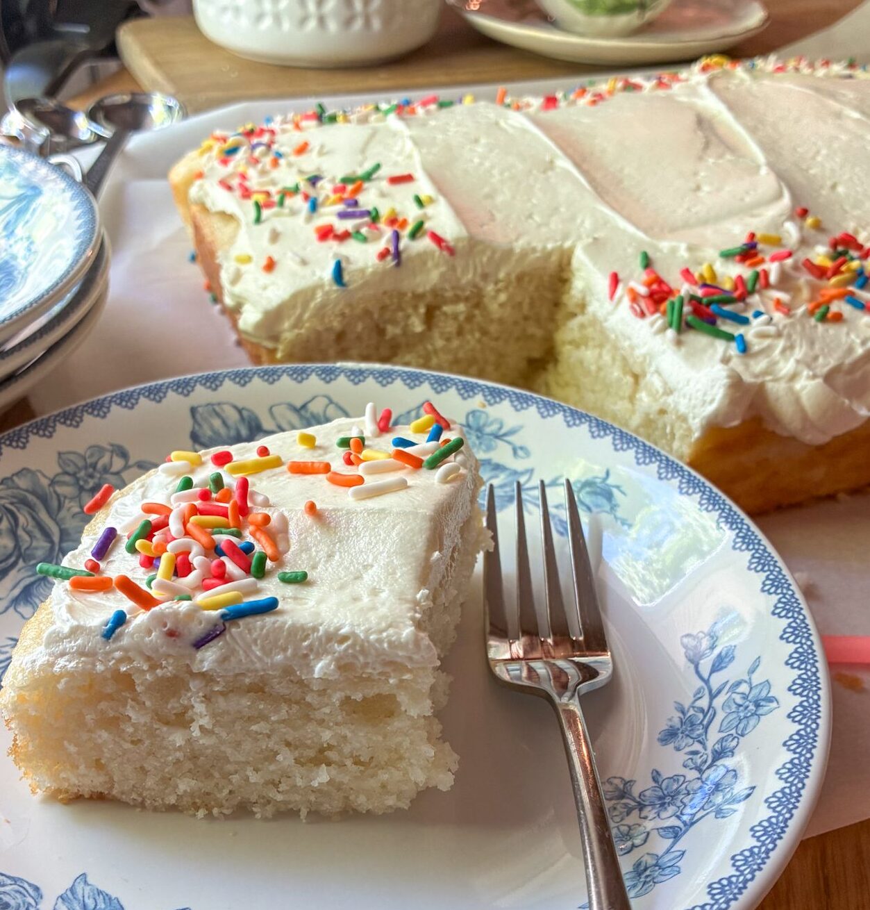 Eggless vanilla sheet cake on a plate with a fork