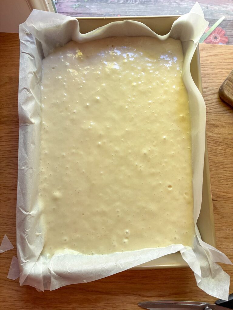 Batter in a sheet cake pan prior to baking for eggless vanilla sheet cake