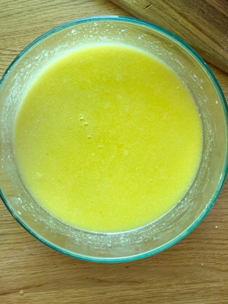 wet ingredients in a large bowl for eggless vanilla sheet cake