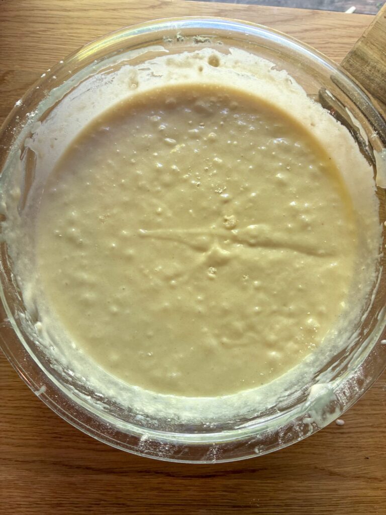 Batter for eggless vanilla sheet cake in a large bowl