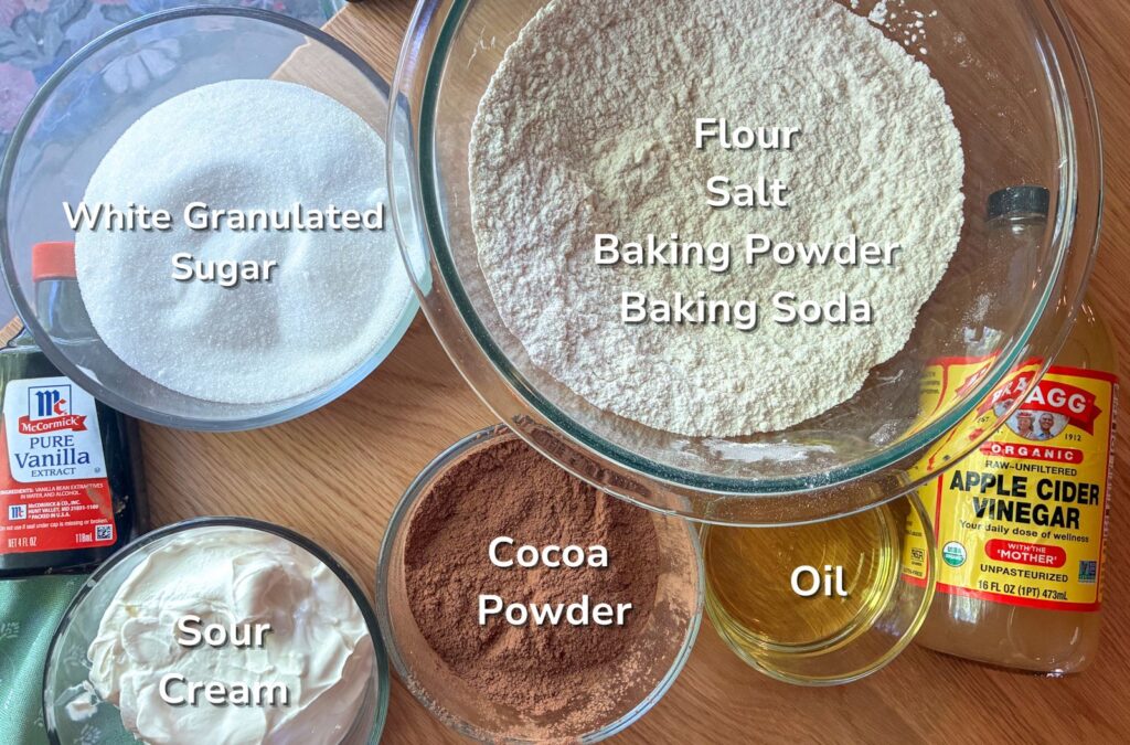 Ingredients laid out on a table with labels for the eggless chocolate cake