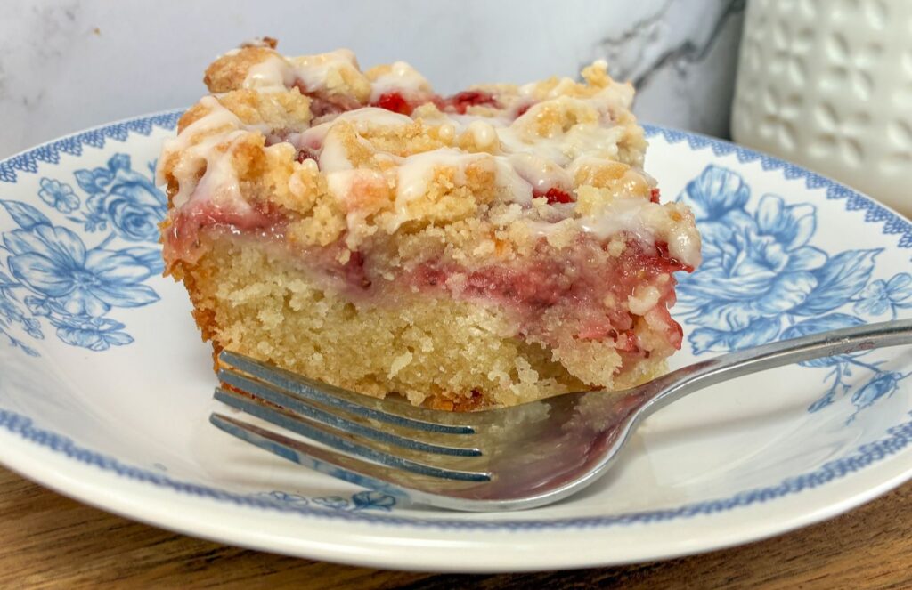 Strawberry crumb cake with a fork on a plate