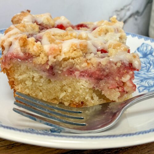 Strawberry crumb cake with a fork on a plate