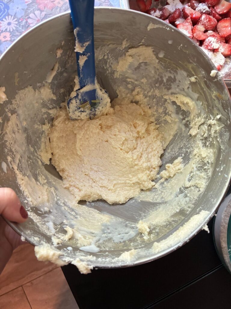 Cake batter in a large bowl for eggless strawberry cake