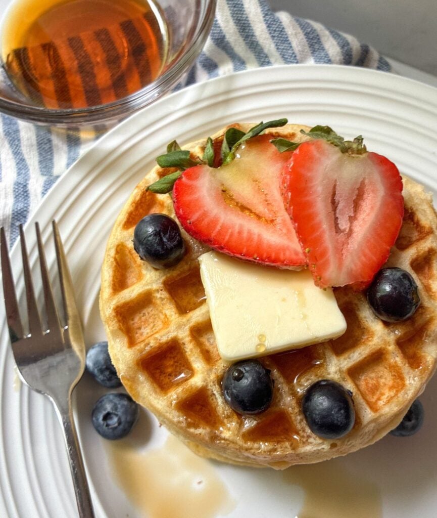 eggless waffles on a plate with fruit on top