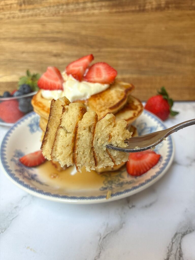 Eggless protein pancakes with a fork holding a bite
