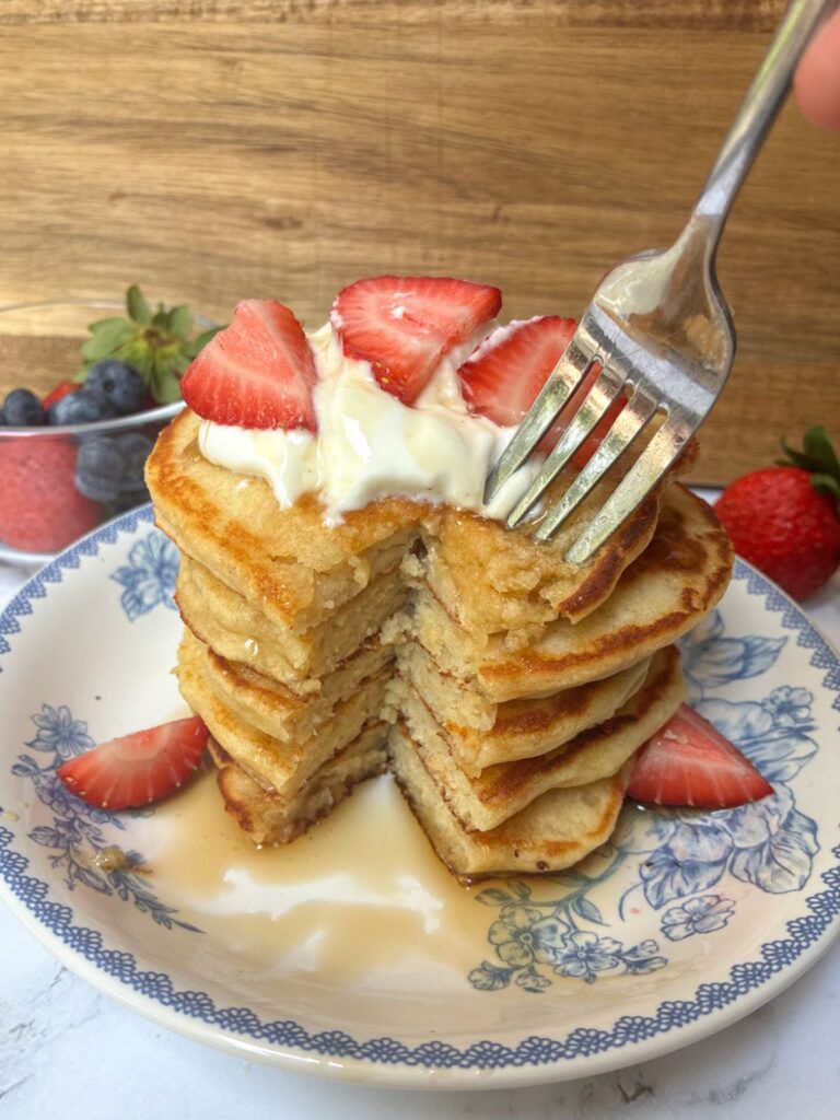 stack of eggless protein pancakes with a bite taken out