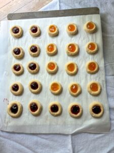 eggless thumbprint cookies on a baking sheet
