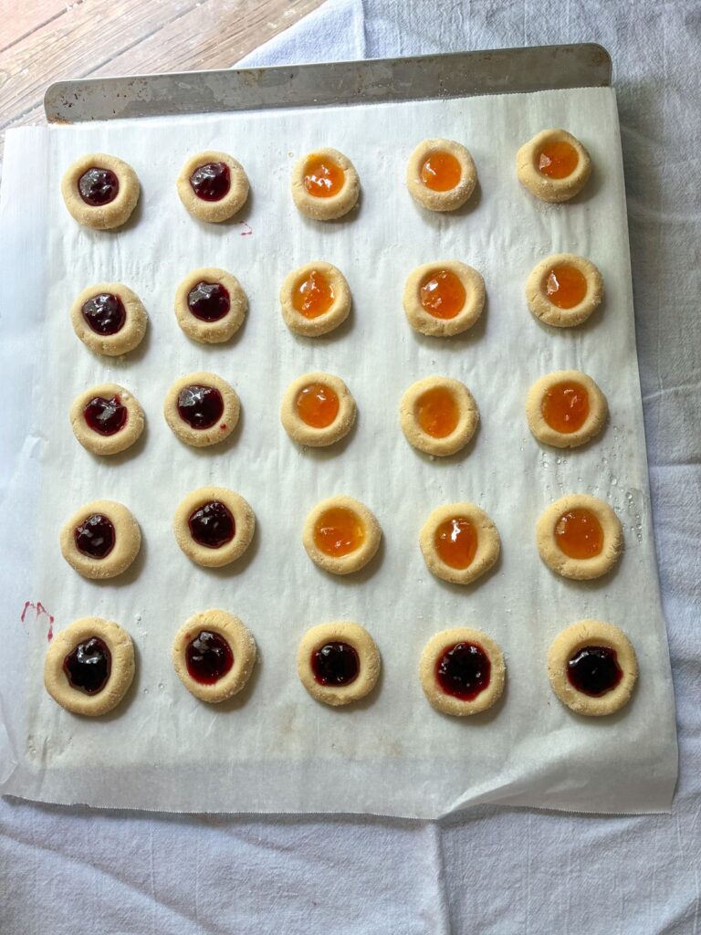 eggless thumbprint cookies on a baking sheet