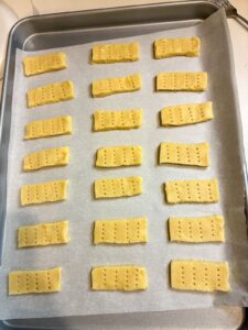 parchment lined baking sheet with shortbread cookies on it
