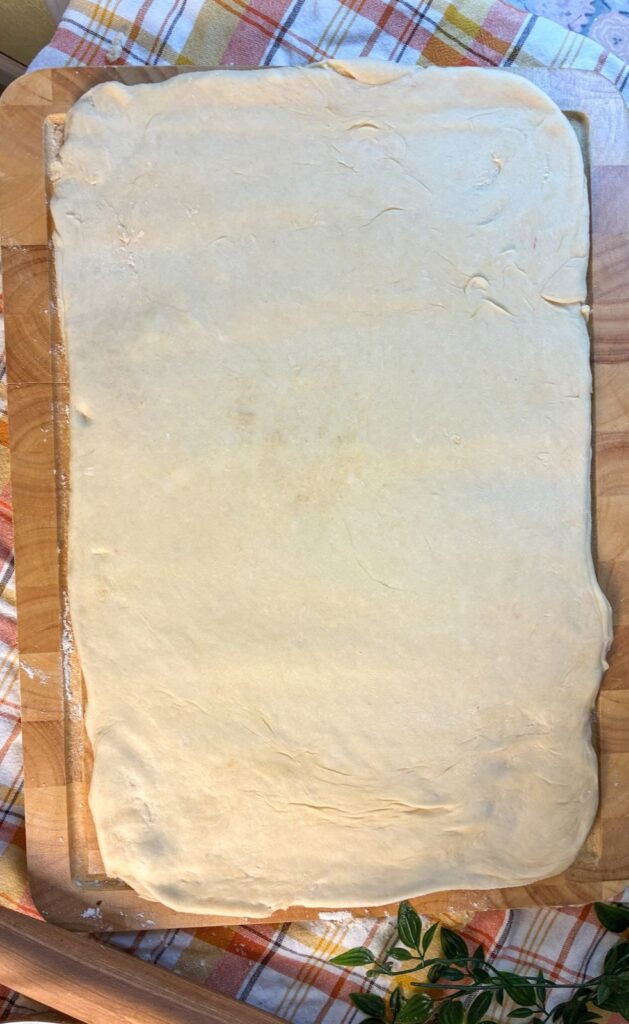 eggless cinnamon roll dough rolled out